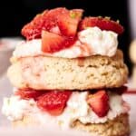 Close-up of an Air Fryer Strawberry Shortcake with layers of fluffy biscuit, luscious whipped cream, and fresh sliced strawberries.