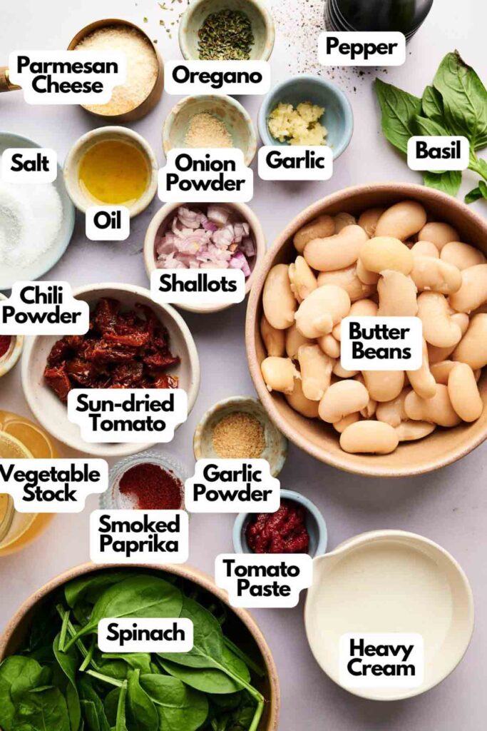 Bowls of ingredients labeled: Marry Me Butter Beans, heavy cream, spinach, sun-dried tomato, shallots, onion powder, garlic powder, smoked paprika, chili powder, oil, salt, pepper, oregano, basil, parmesan.