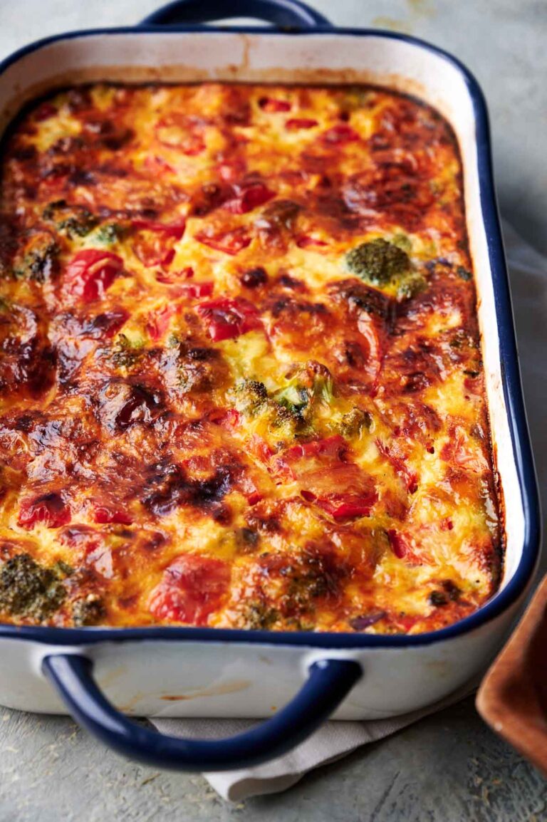 A baked Egg Casserole dish filled with a golden-brown, cheesy, and vegetable-studded frittata.