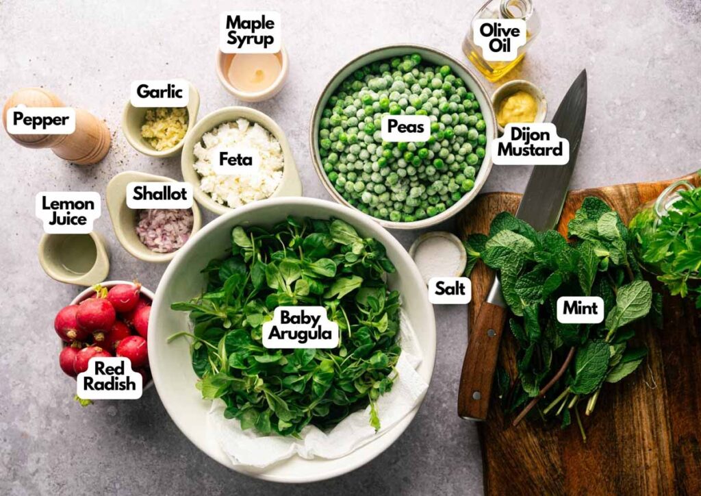 A vibrant Pea Salad display featuring labeled ingredients like baby arugula, mint, feta, radish, peas, shallot, garlic, lemon juice, maple syrup, olive oil, Dijon mustard, salt, and pepper.