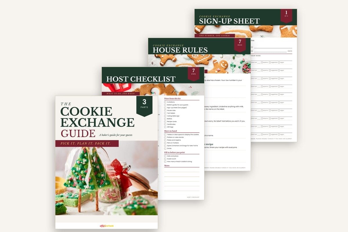 The cookie exchange kit printables: the baker's guide cover with the host checklist, house rules and sign-up sheet behind it.